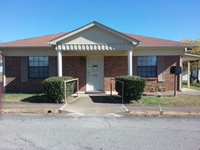 Mcewen apartment for rent - a small brick house with a white front door